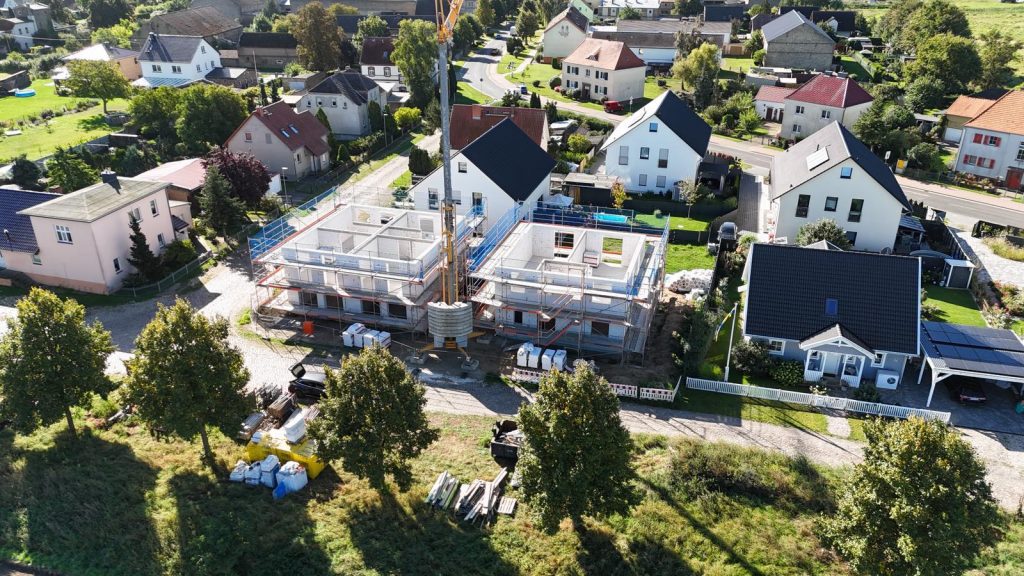 Rohbau eines Wohnhauses zwischen bestehenden Häusern